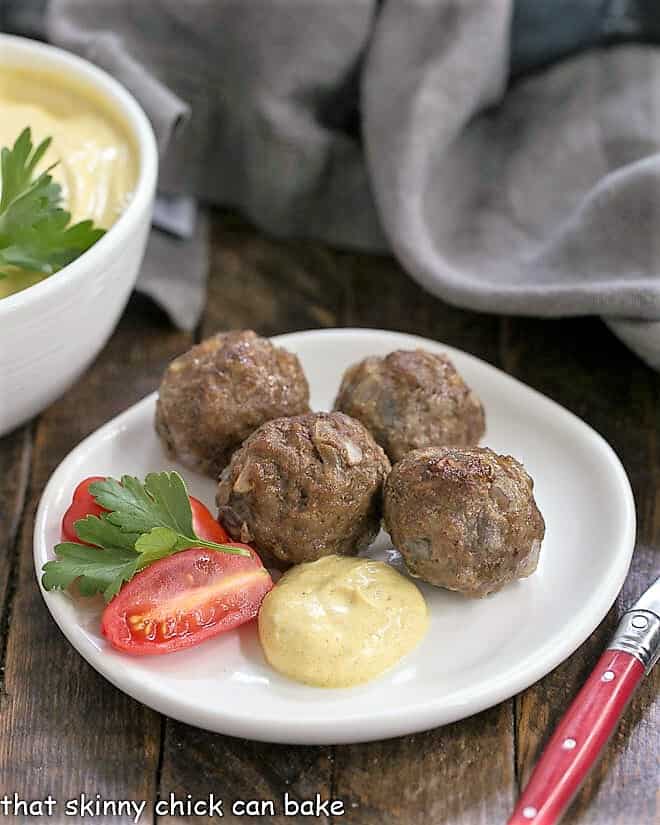 Indian Meatballs with Yogurt Sauce on a white appetizer plate