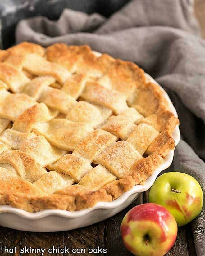 Perfect Apple Pie from Scratch - A cinnamon spiced apple pie with a flaky lattice crust! A couple tricks make this the best recipe for a classic apple pie! Perfect Apple Pie in a ceramic pie plate.