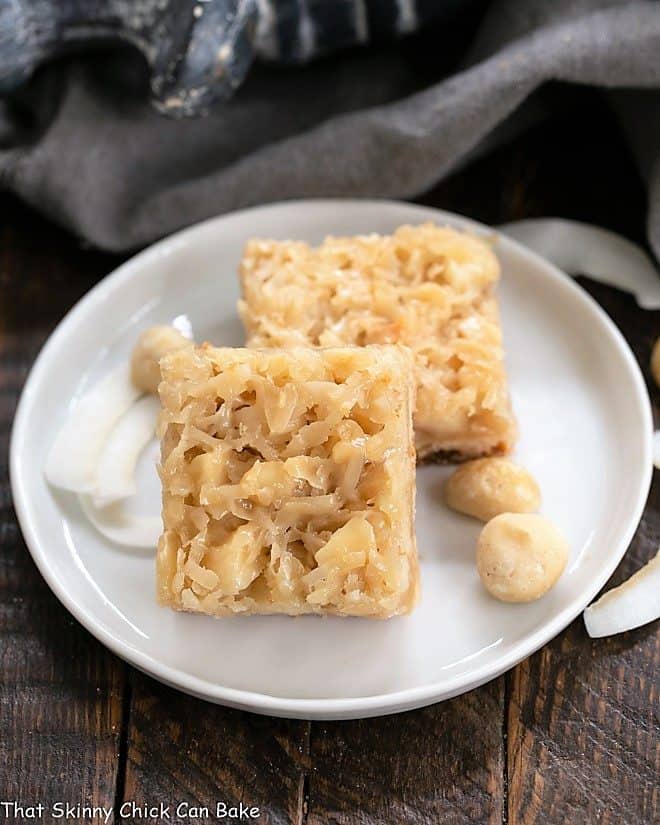 Coconut Macadamia Nut Bars on a round white ceramic plate.