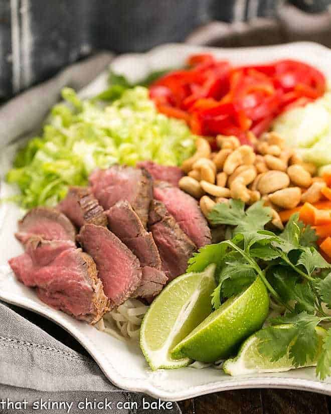Half of a Vietnamese Beef Noodle Bowl on a white platter.