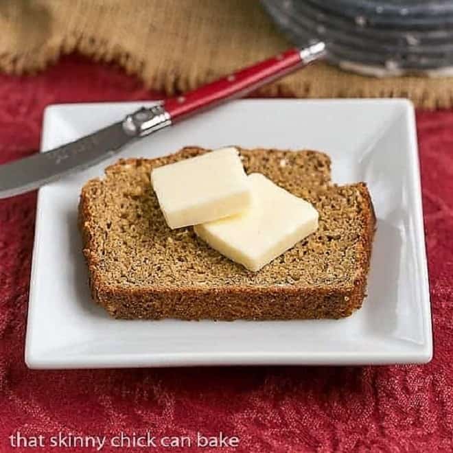 Easy Irish Brown Bread slice topped with butter on a square white plate.