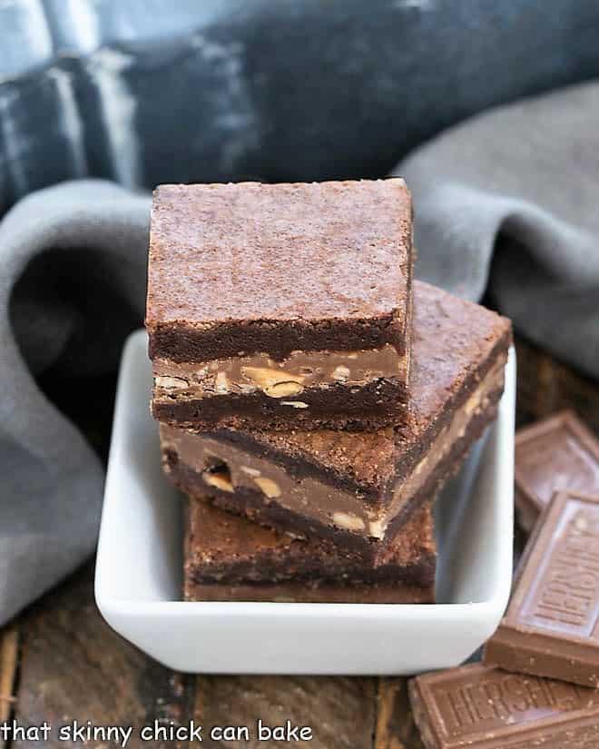 Symphony Toffee Brownies - rich, fudgy brownies with a milk chocolate, almond, toffee filling that pushes these over the top!!! 3 Symphony Toffee Brownies in a small square bowl.