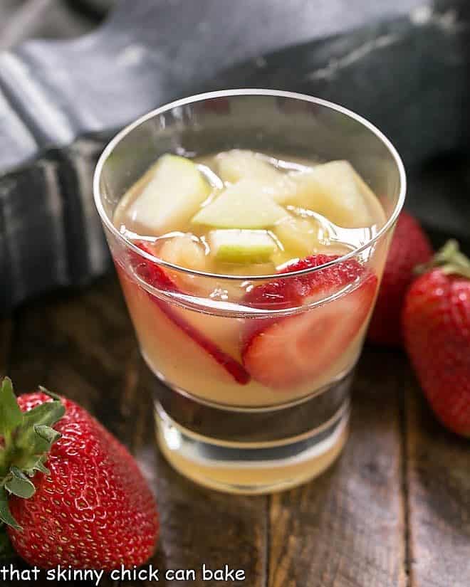 White Wine Sangria in a highball glass full of fruit.