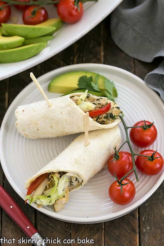 Overhead view of a plate of chicken tacos with a red handle fork.