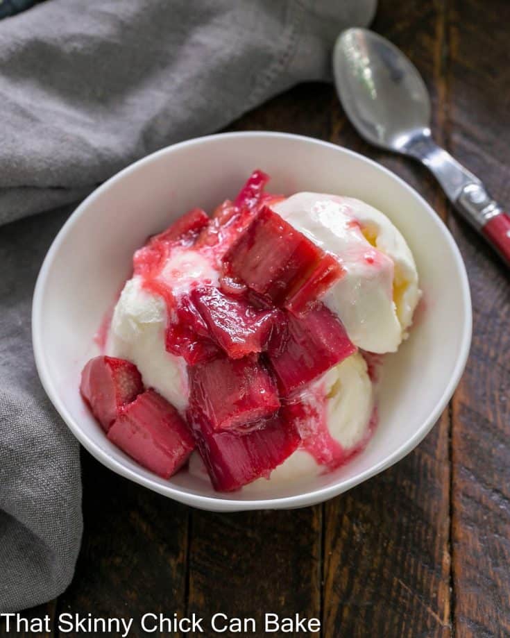Rhubarb compote on vanilla ice cream in a white bowl