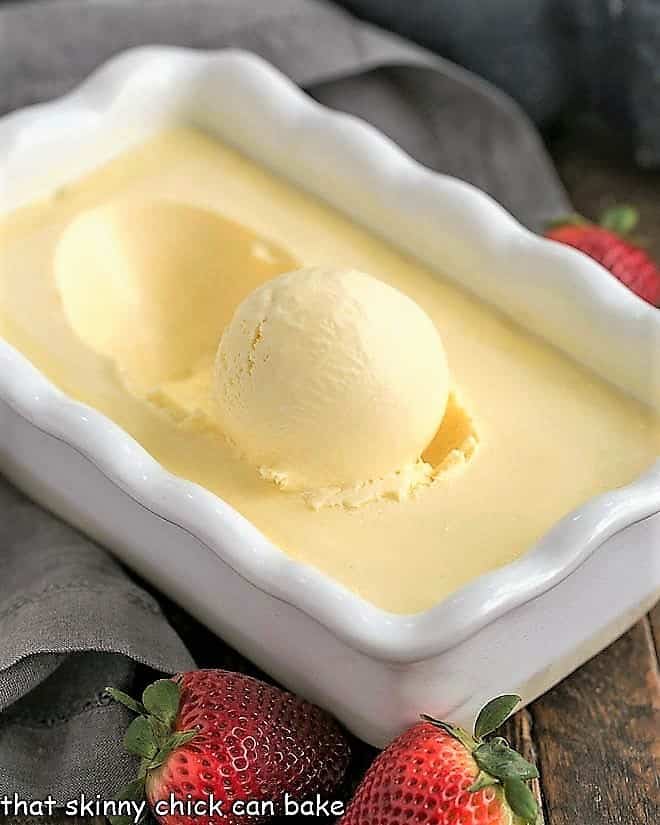 Cheesecake Ice Cream - rich, luscious ice cream reminiscent of cheesecake Cheesecake Ice Cream in a white ceramic loaf pan with fresh strawberries