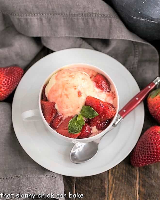Cheesecake Ice Cream with Strawberry Sauce - rich, luscious ice cream reminiscent of cheesecake topped with a sweet berry sauce Cheesecake Ice Cream with Strawberry Sauce in a teacup viewed from above.