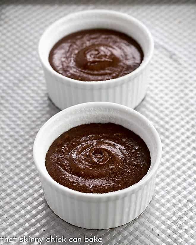 Chocolate lava cake batter in ramekins.
