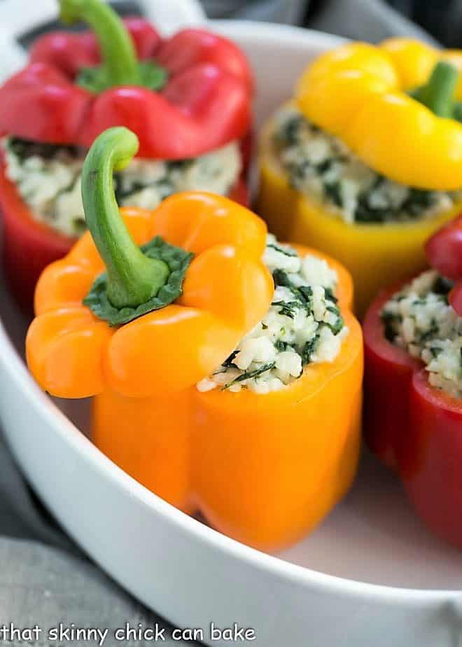 Rice Packed Peppers ready for the oven in a white baking dish
