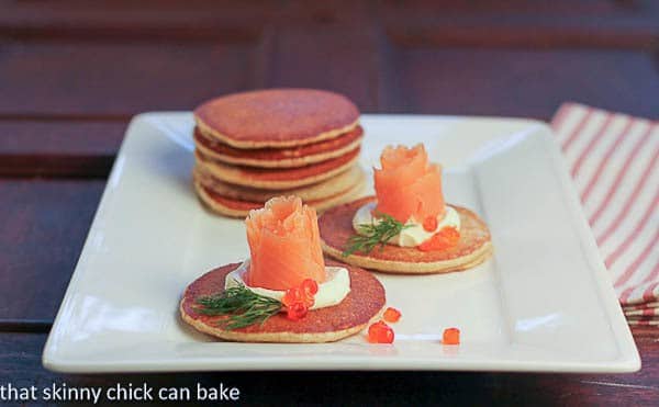 Mini buckwheat pancakesi with Smoked Salmon Roses - an elegant appetizer Buckwheat Blini with Smoked Salmon Roses on a serving tray