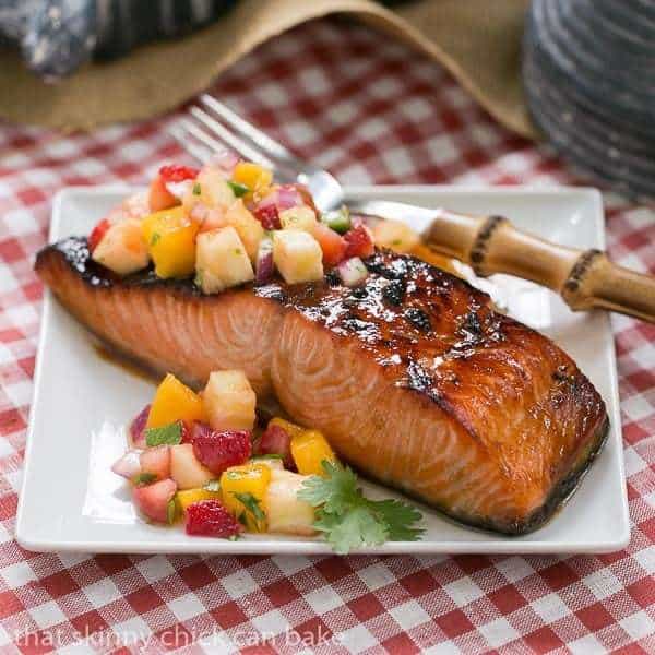 Maple Glazed Salmon - A super easy soy and maple marinated salmon that's cooked under the broiler Maple Glazed Salmon on a square white plate topped with fruit salsa.