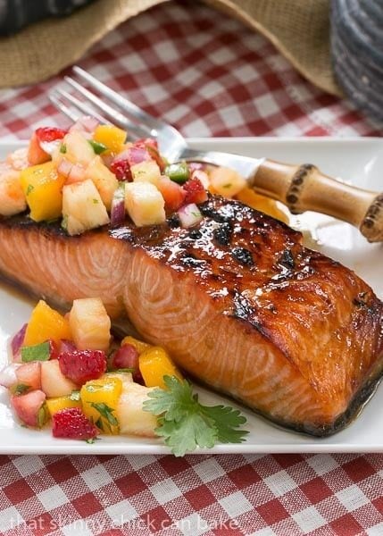 Maple Glazed Salmon - A super easy soy and maple marinated salmon that's cooked under the broiler Maple Glazed Salmon on a square white plate on a red and white checked napkin.