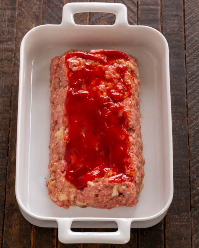Meat shaped into a loaf and coated with ketchup.