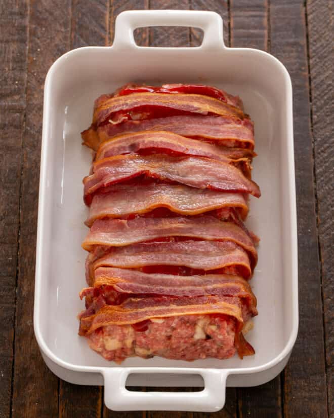 Meatloaf covered with par-cooked bacon.