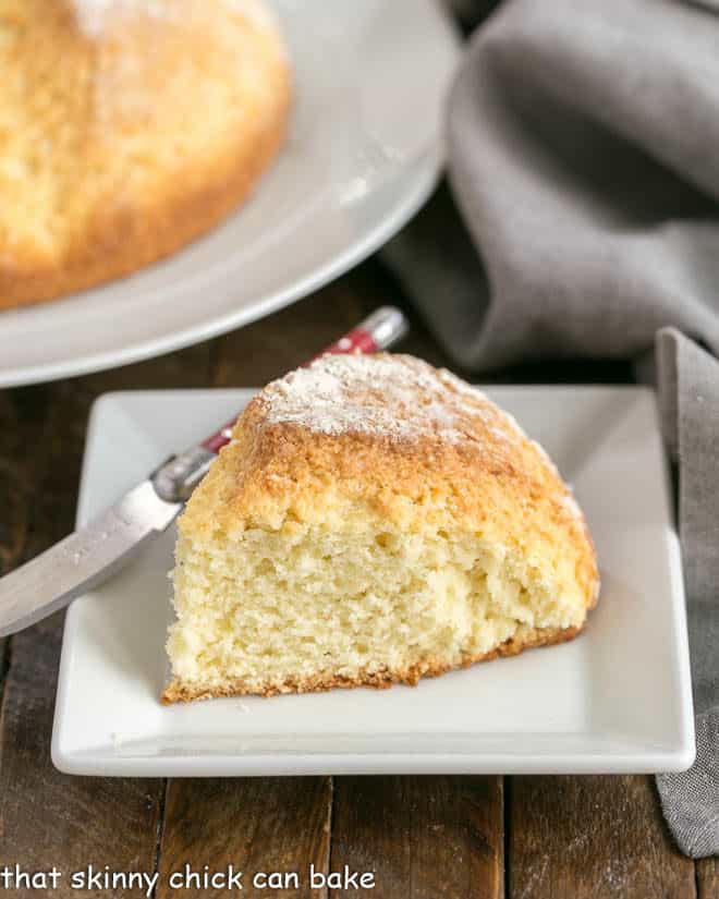 Irish soda bread slice on a white ceramic plate.