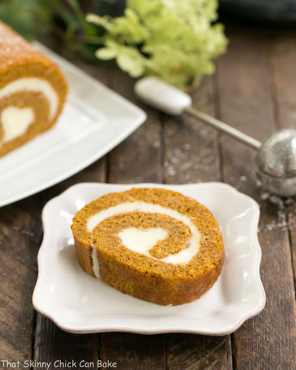 Libbys Pumpkin Roll - With a cream cheese filling, this classic fall treat always gets rave reviews! Old Fashioned Pumpkin Roll slice and a square ceramic dish.