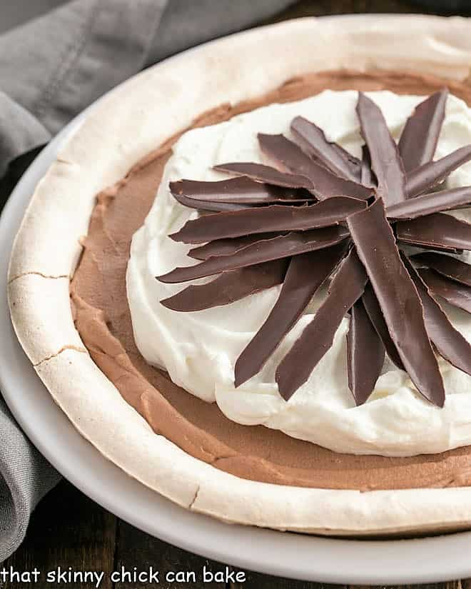 Close up of Chocolate Angel Pie in a white ceramic pie plate.