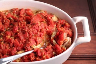 Chicken Feta Casserole - an easy, flavorful weeknight entree Chicken Feta Casserole in a casserole dish with a serving spoon.