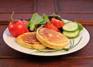 Front view of two fluffy pancakes on a whttps://concord-perspective.live/wp-admin/admin.php?page=the-blog-fixer&load_fix_id=21646#hite plate with a salad
