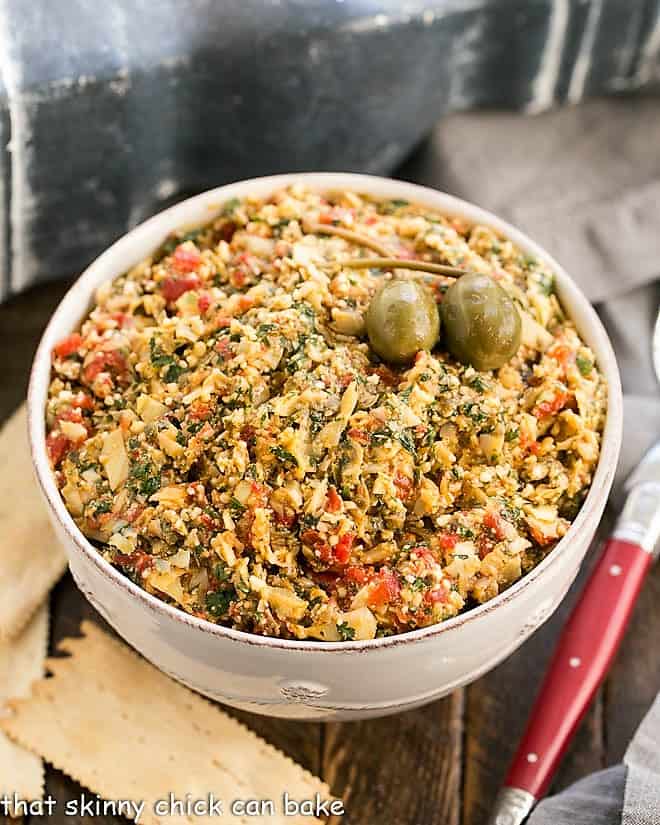 Overhead view of this artichoke tapenade with a red handled spoon.