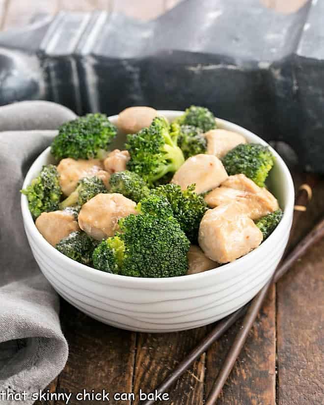 Chicken and Broccoli Stir Fry - A speedy, delicious meal with an Asian flair with homemade stir fry sauce. Make a better than take out dish at home! Broccoli chicken in a white bowl