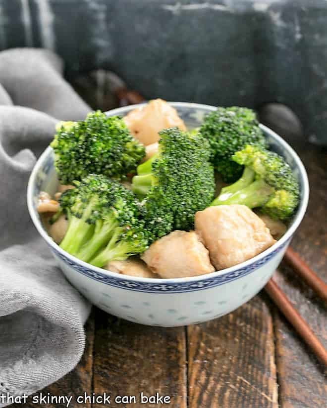 Broccoli and Chicken Stir Fry - A speedy, delicious meal with an Asian flair. Make better than take out at home! broccoli and chicken in a blue and white ceramic bowl