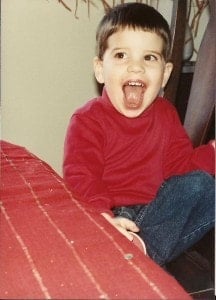 Tom Berg Age 3 ready to eat his Chocolate Cake from Scratch The birthday boy as a child in a red shirt and jeans with a big smile