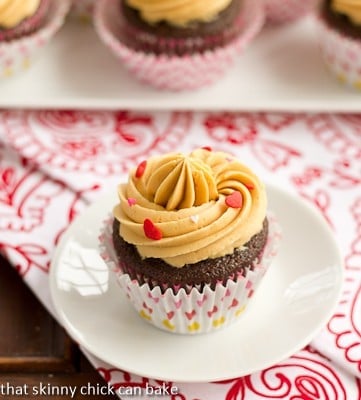 Stout Cupcakes (5) A chocolate cupcake with a swirl of caramelized white chocolate ganache on a small white plate.
