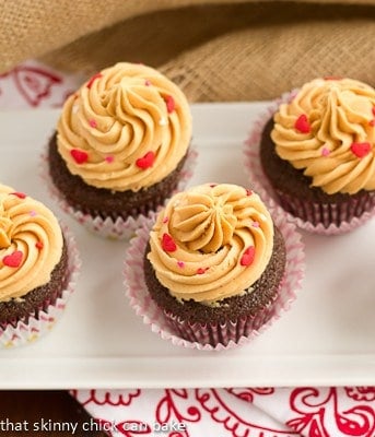 Overhead view of frosted chocolate cupcakes on a white tray
