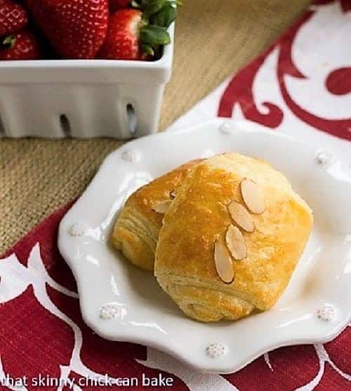 Homemade Classic Croissants - Heavenly, tender, flaky and buttery results! Homemade Classic Croissants filled with almond paste on a white plate.