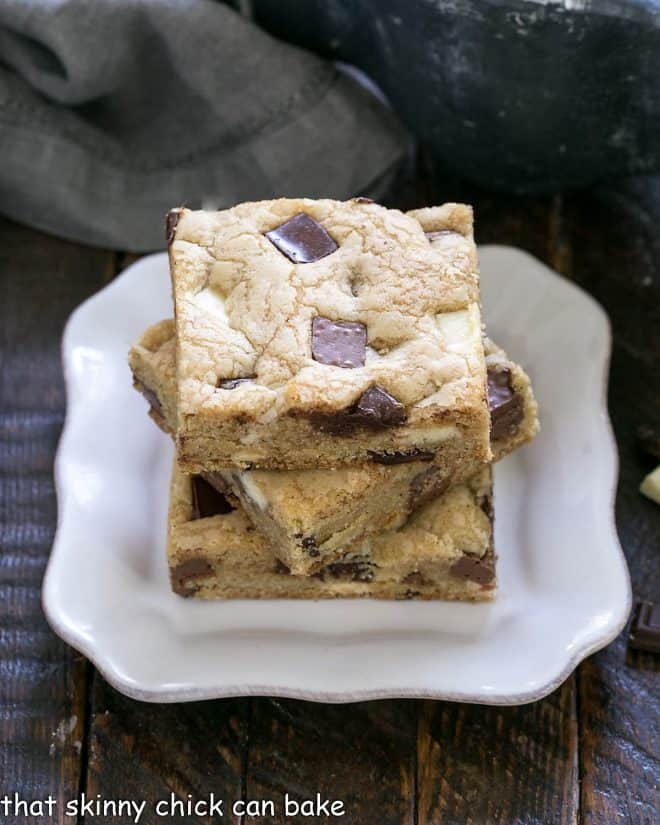 3 chocolate chunk bars stacked on a square white plate