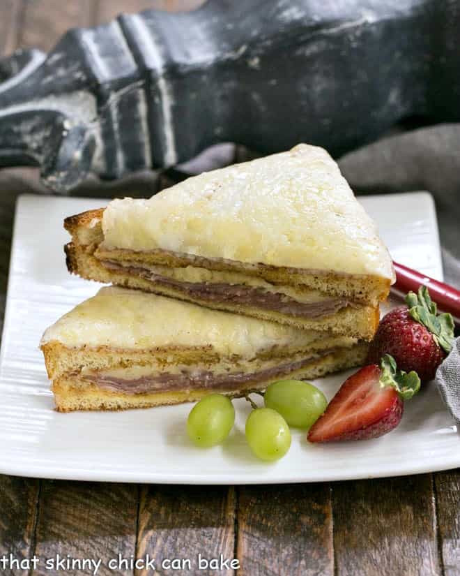 French Ham and Cheese Sandwich stacked on a square white plate.
