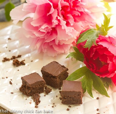 A nearly empty platter of Refrigerator Brownies with some pink peonies