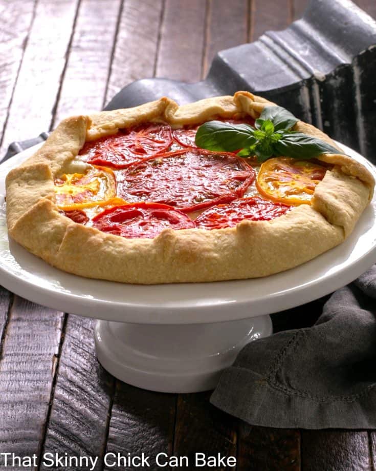 tomatoe galette recipe on a white cake stand