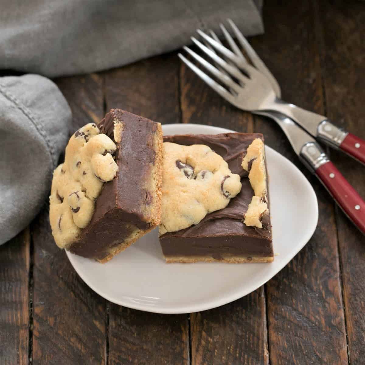 2 Fudge and Toffee Filled Chocolate Chip Bars on an oval plate with 2 forks.