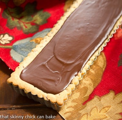 Chocolate Chip Cookie Tart with Caramel and Chocolate Glaze in a rectangular tart pan.