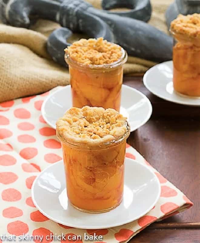 Peach Crisp in Jars on white saucers.