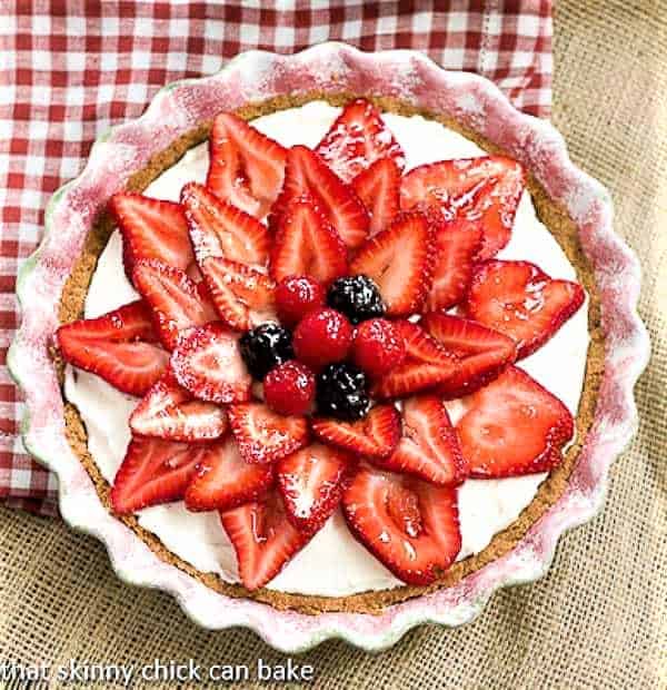 Strawberry Cream Cheese Pie - A dreamy cream cheese and whipped cream filling topped with juicy ripe strawberries! Strawberry Cream Cheese Dessert in a ceramic pie plate