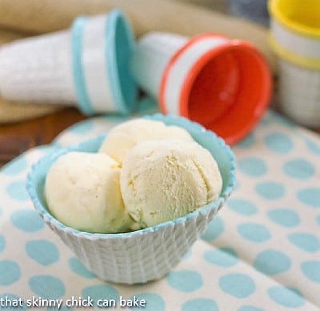 Vanilla Ice Cream Recipe - Simple, luscious vanilla bean ice cream flavored with real vanilla bean paste Vanilla Bean Ice Cream in a white and turquoise ice cream bowl on a polka dot napkin.
