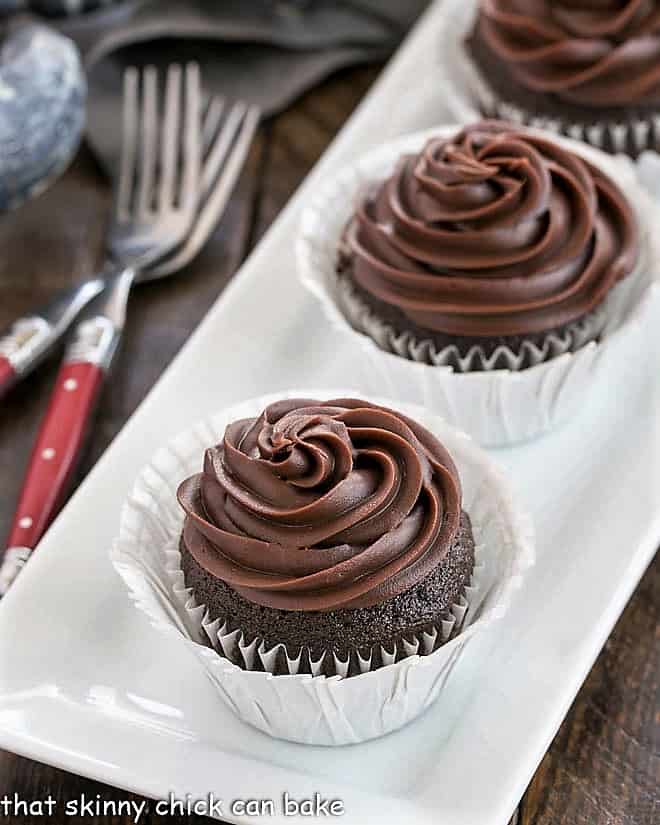 Blender cupcakes on a white tray with red handled forks.