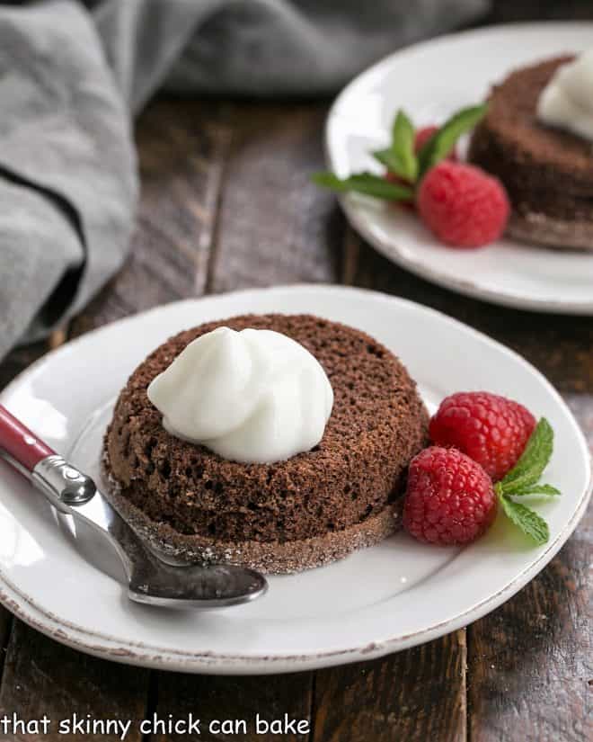 Lava cakes garnished with cream and berries.