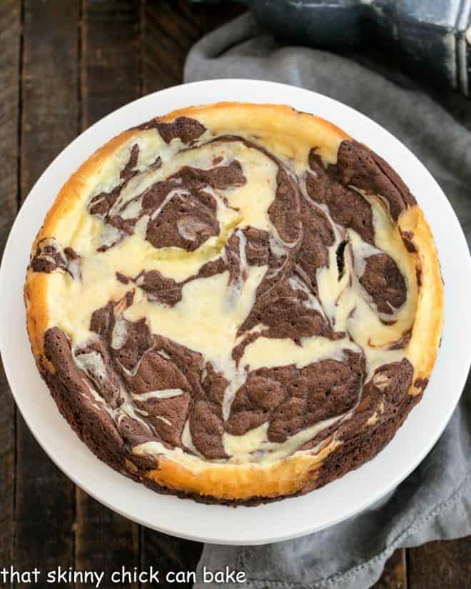 Marbled Overhead view of Marbled Flourless Chocolate Cake on a white cake stand.