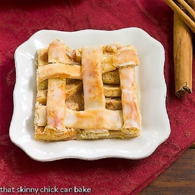 A slice of apple slab pie or apple squares on a white plate