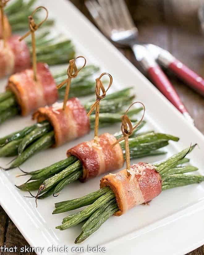 Green Bean and Bacon Bundles wrapped in bacon on a white tray