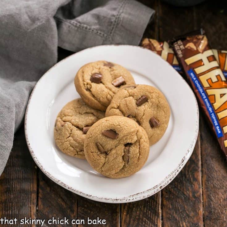 Overhead view of biscoff cookies on a white plate next to 2 Heath bars