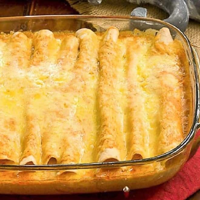 Cheesy Chicken Enchiladas in a Pyrex casserole dish.