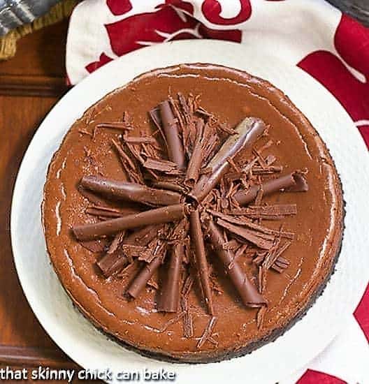 Double Chocolate Cheesecake on a white plate with chocolate curls