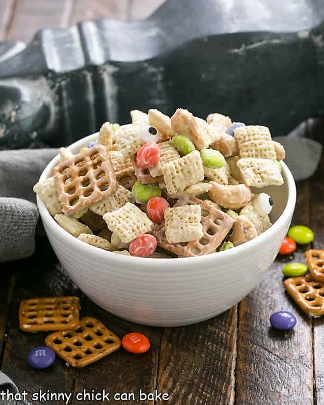 White bowl filled with white chocolate chex mix.