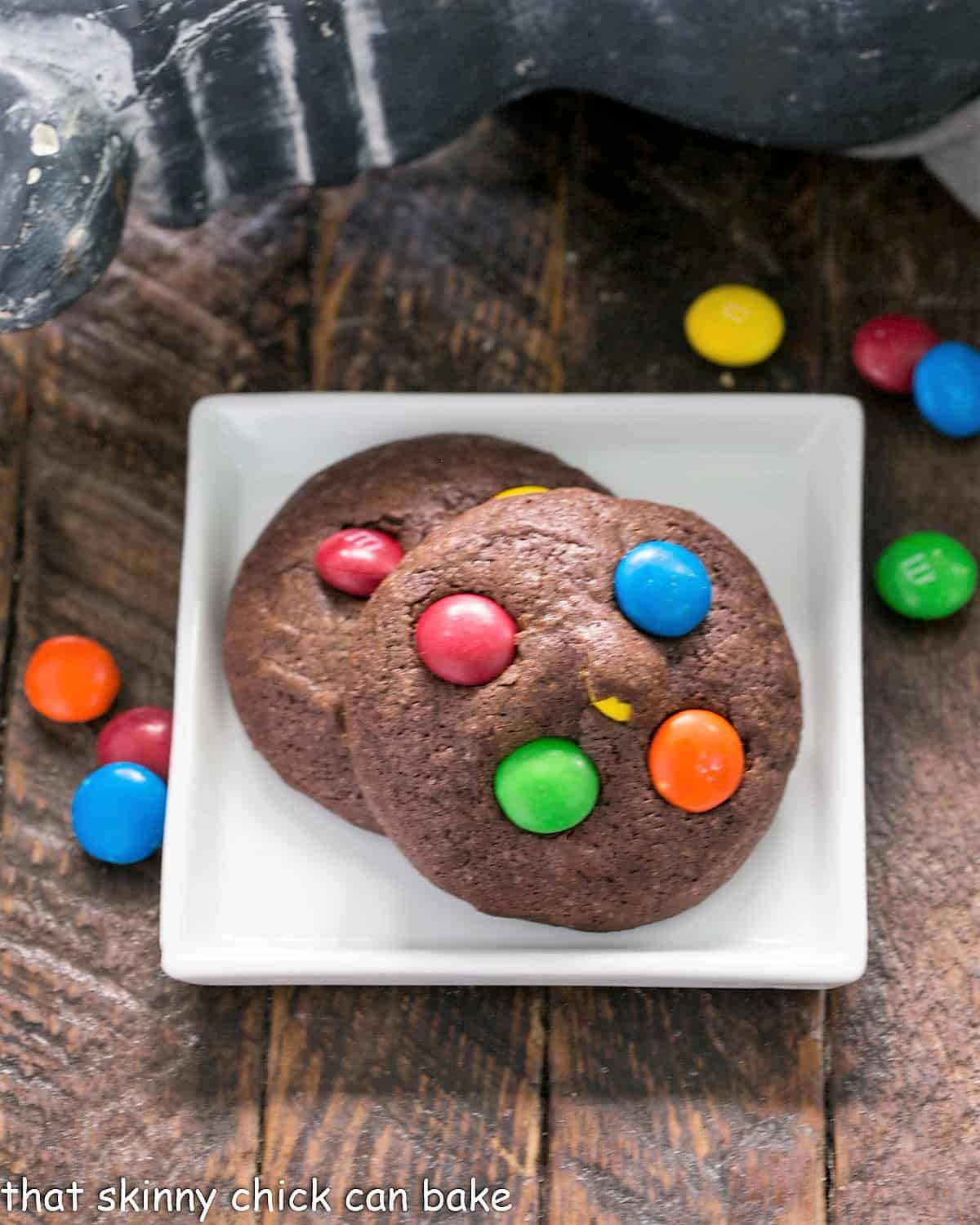 2 brownie cookies on a small white plate.