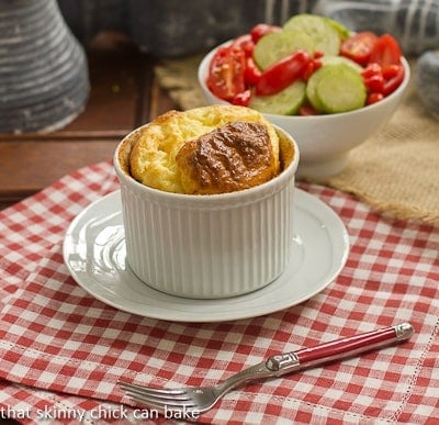 Muenster_Soufflé in a white ramekin on a white saucer.